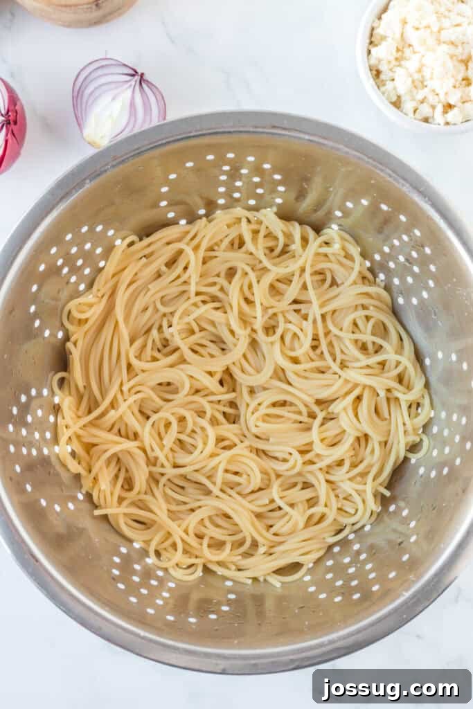 Creamy Mexican Verde Spaghetti (Espagueti Verde) 11 Cooked spaghetti drained in colander for creamy poblano pasta recipe