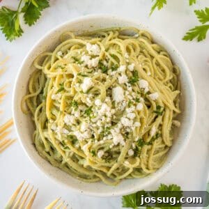Creamy Mexican Verde Spaghetti (Espagueti Verde) 15 Square image of Mexican Green Spaghetti topped with queso fresco and parsley