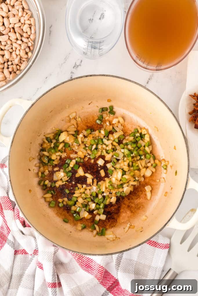 Ranchero Pinto Beans with Bacon — Flavorful Skillet Recipe 11 Pinto beans, bacon, tomatoes, broth, and spices added to a Dutch oven for Ranchero Beans