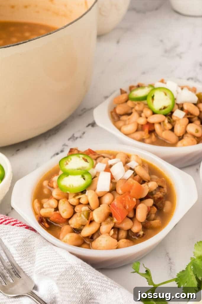 Ranchero Pinto Beans with Bacon — Flavorful Skillet Recipe 14 Bowls of Ranchero Beans topped with jalapeño slices and chopped onion