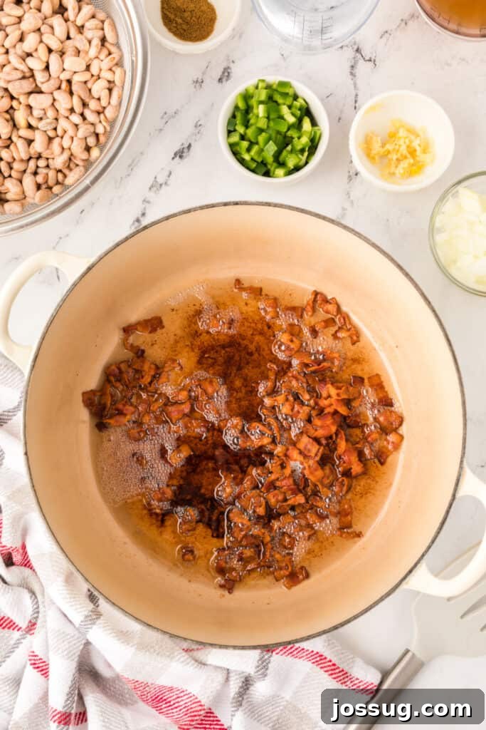 Ranchero Pinto Beans with Bacon — Flavorful Skillet Recipe 8 Crispy bacon and rendered bacon grease in a Dutch oven for Ranchero Beans