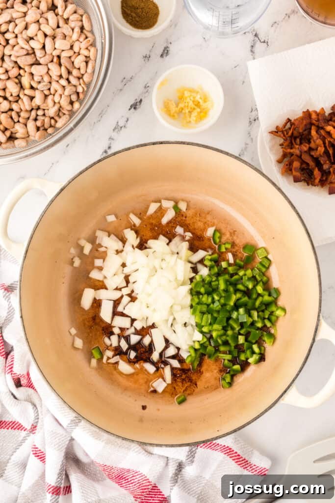 Ranchero Pinto Beans with Bacon — Flavorful Skillet Recipe 9 Onion and jalapeño cooking in bacon grease for Ranchero Beans