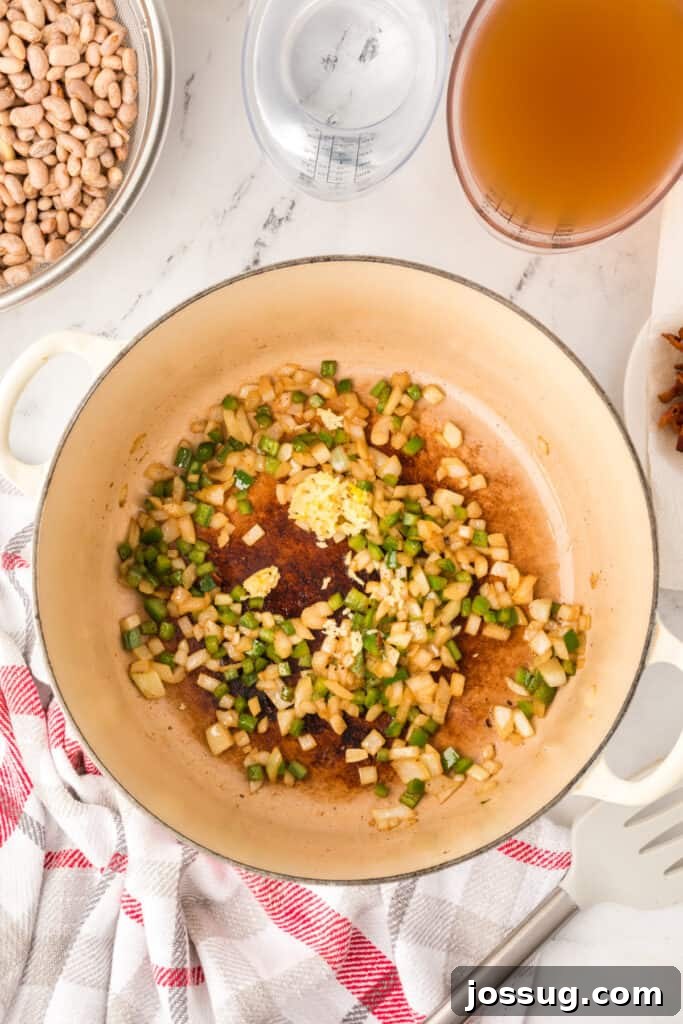Ranchero Pinto Beans with Bacon — Flavorful Skillet Recipe 10 Garlic added to sautéed onion and jalapeño for Ranchero Beans