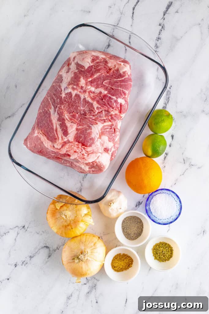 Slow Cooker Carnitas ingredients with pork shoulder, onions, garlic, orange, lime, and seasonings
