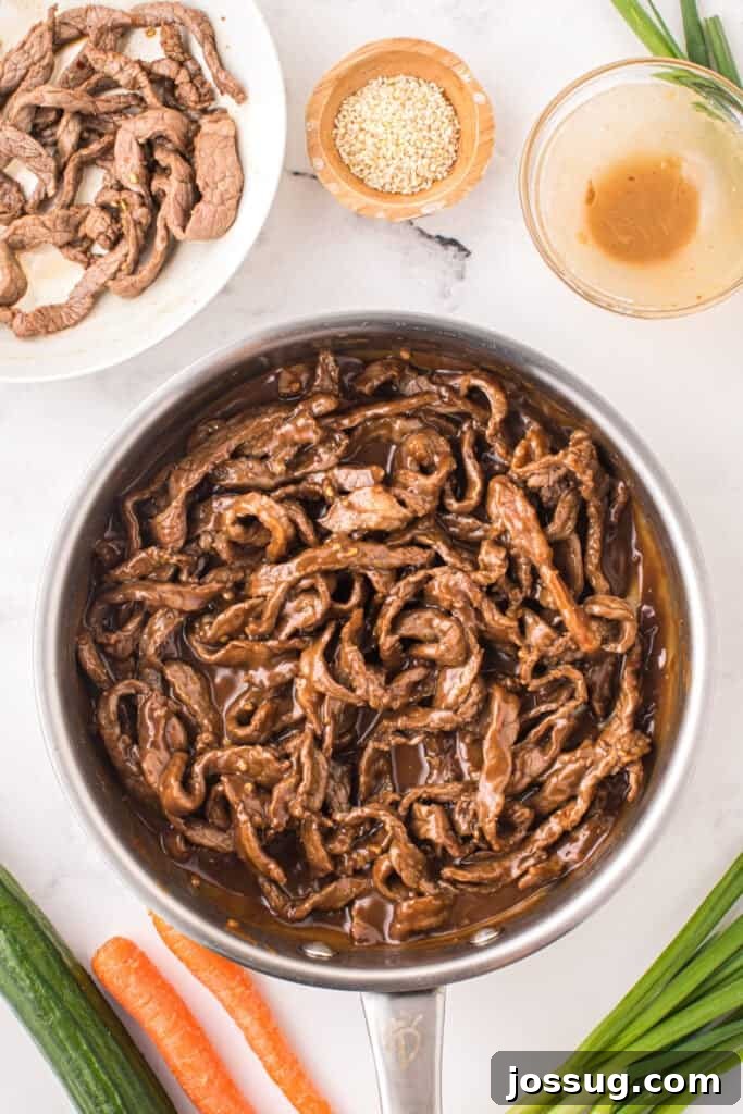 Korean Beef Bulgogi with cooked beef strips coated in thick savory bulgogi sauce in a skillet