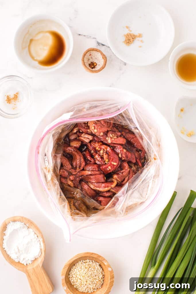 Marinated beef strips soaking in bulgogi marinade inside a sealable bag for Korean Beef Bulgogi