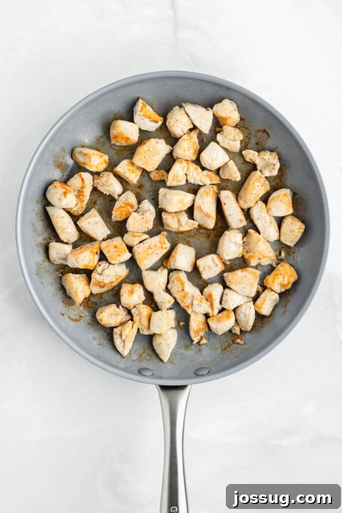 Bite-sized chicken pieces cooking in a skillet for easy Chicken Teriyaki