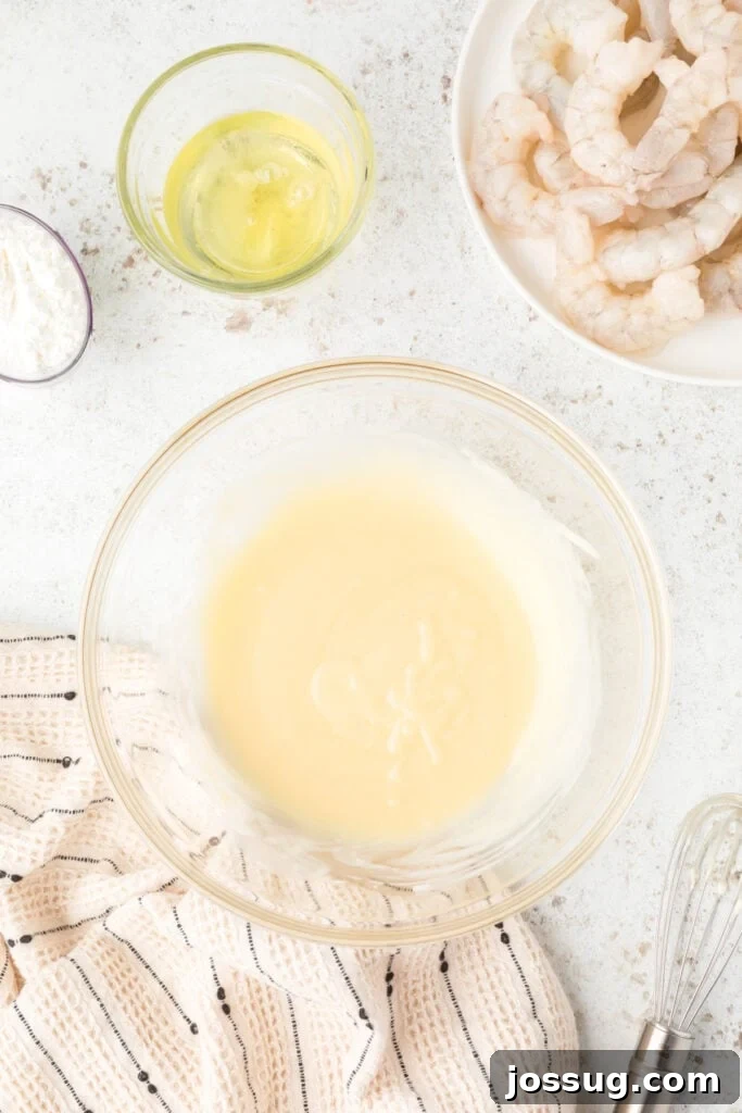 Crispy Honey Walnut Shrimp Recipe: Restaurant-Style at Home 11 Creamy homemade Honey Walnut Shrimp sauce mixed in a glass bowl