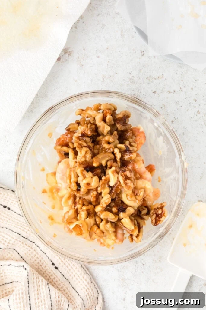 Crispy Honey Walnut Shrimp Recipe: Restaurant-Style at Home 18 Honey Walnut Shrimp topped with candied walnuts in a glass bowl