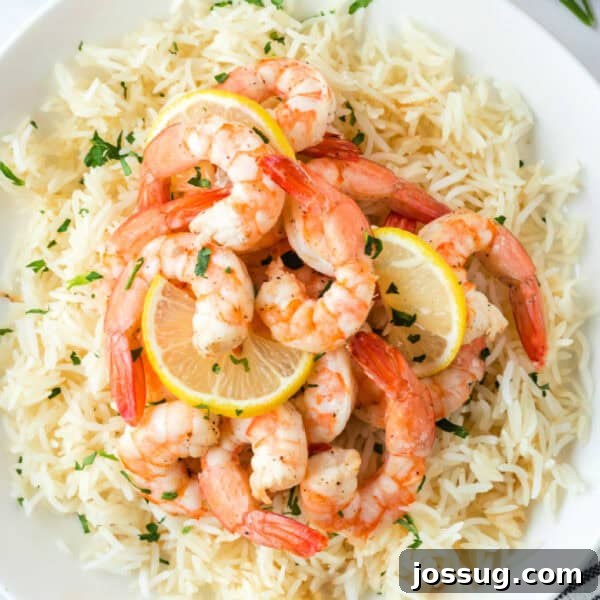 Crispy Honey Walnut Shrimp Recipe: Restaurant-Style at Home 25 Square crop of Air Fryer Shrimp with lemon slices served over rice.
