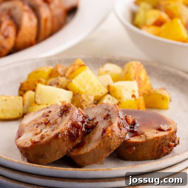 Crispy Honey Walnut Shrimp Recipe: Restaurant-Style at Home 26 Sliced honey garlic pork tenderloin on a plate with roasted potatoes and glaze spooned over the top.