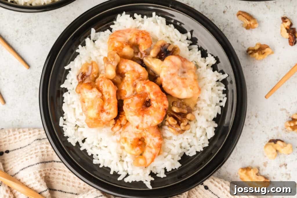 Crispy Honey Walnut Shrimp Recipe: Restaurant-Style at Home 6 Honey Walnut Shrimp served over steamed white rice in a black bowl