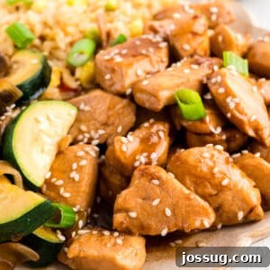 Homemade Hibachi Chicken: Restaurant-Style Recipe You’ll Love 15 Square image of Hibachi Chicken with fried rice, zucchini, mushrooms, sesame seeds, and green onions for an easy Japanese steakhouse-style recipe.