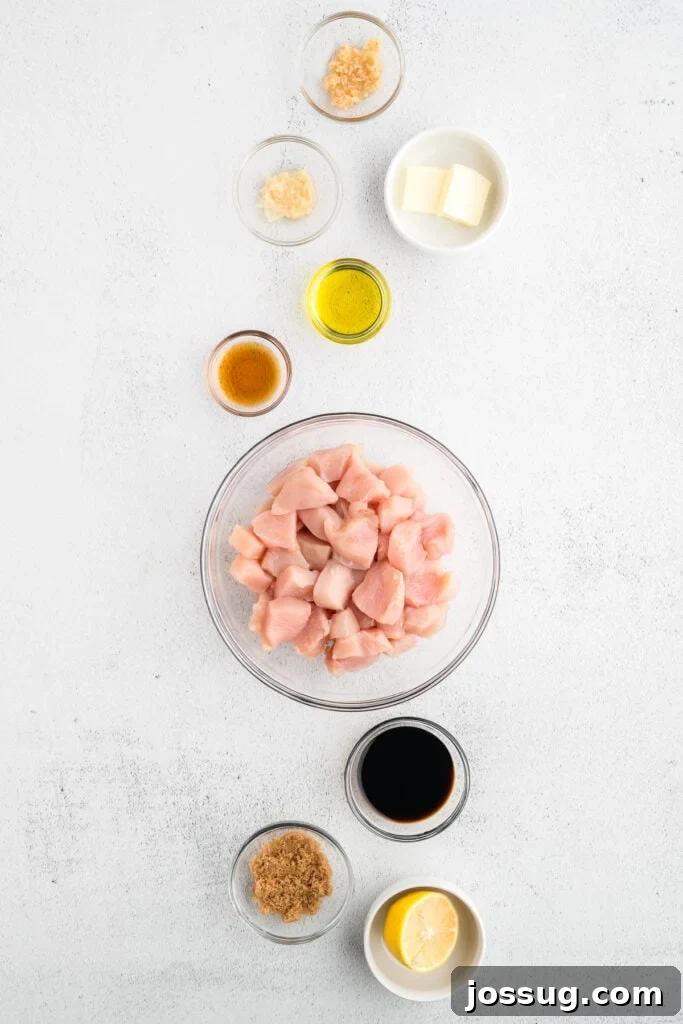Homemade Hibachi Chicken: Restaurant-Style Recipe You’ll Love 3 Overhead view of raw chicken breast pieces with soy sauce, sesame oil, garlic, ginger, brown sugar, butter, and lemon arranged for an easy Hibachi Chicken recipe.