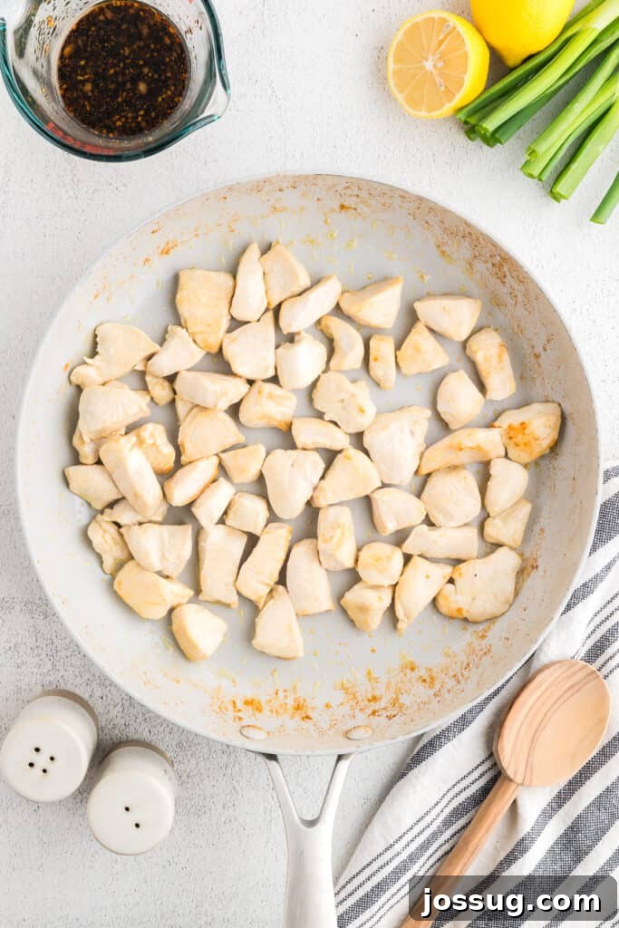 Homemade Hibachi Chicken: Restaurant-Style Recipe You’ll Love 7 Chicken breast pieces searing in a skillet while making homemade Hibachi Chicken for a quick Japanese steakhouse-style dinner.