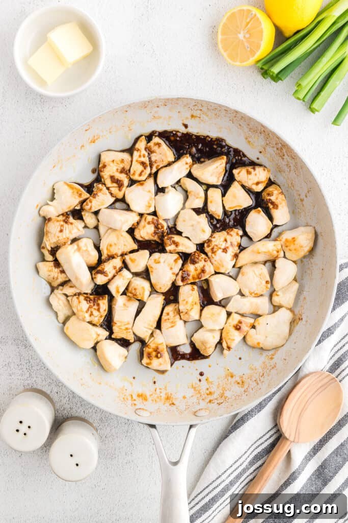 Homemade Hibachi Chicken: Restaurant-Style Recipe You’ll Love 9 Chicken coated with savory hibachi sauce cooking in a skillet for homemade Japanese steakhouse-style Hibachi Chicken.