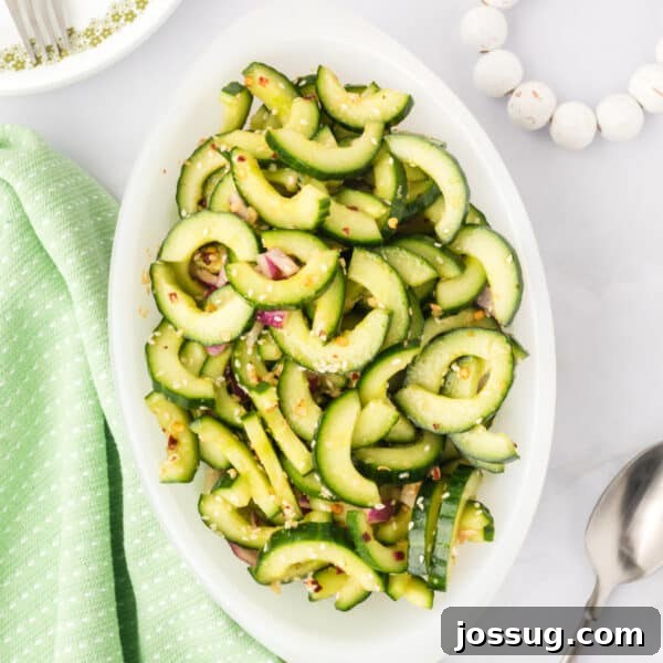 Copycat Hibachi Shrimp Recipe: Restaurant-Style at Home 18 overhead view of cucumber salad in a serving dish with sesame seeds and red onion