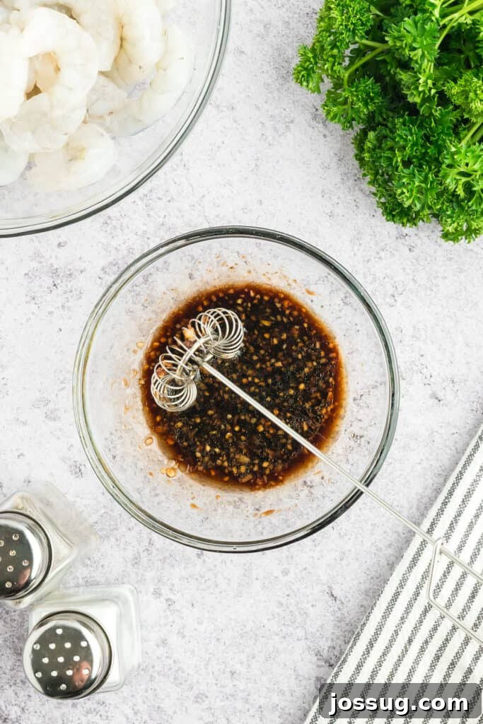 Copycat Hibachi Shrimp Recipe: Restaurant-Style at Home 6 Hibachi Shrimp marinade being whisked together in a glass mixing bowl.