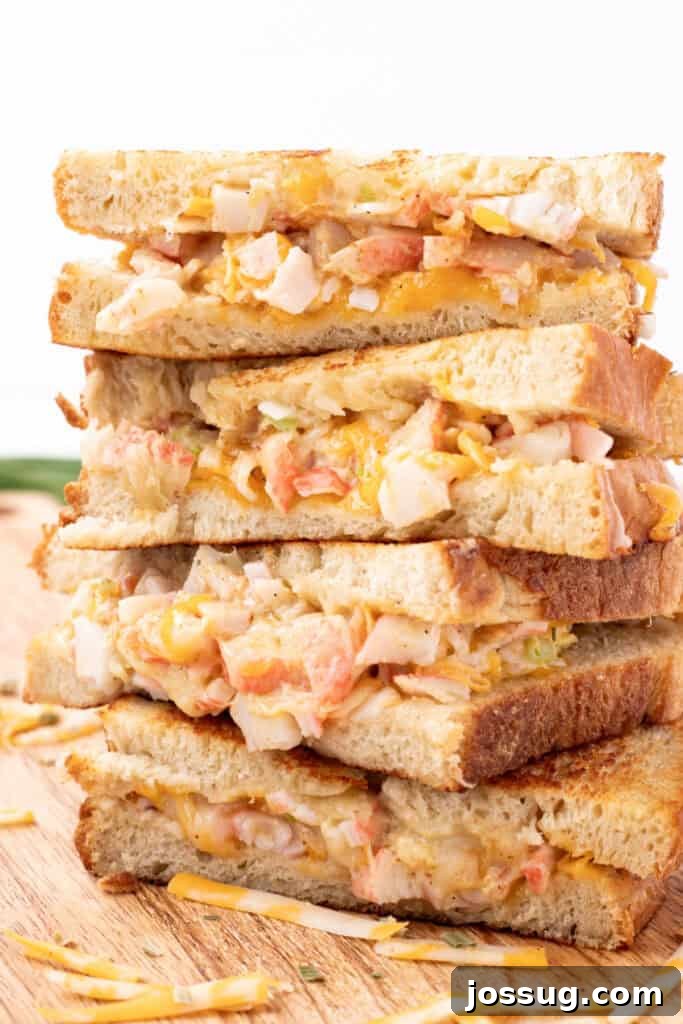 Cheesy Crab Melt: Seafood Grilled Cheese Sandwich Recipe 14 Close-up of stacked Cheesy Crab Melt sandwich halves showing the cheesy crab filling