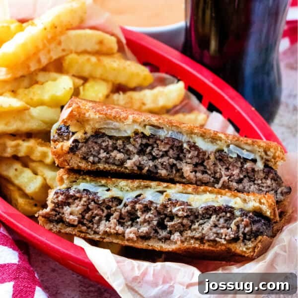 Cheesy Crab Melt: Seafood Grilled Cheese Sandwich Recipe 19 patty melt cut in half in red basket with fries