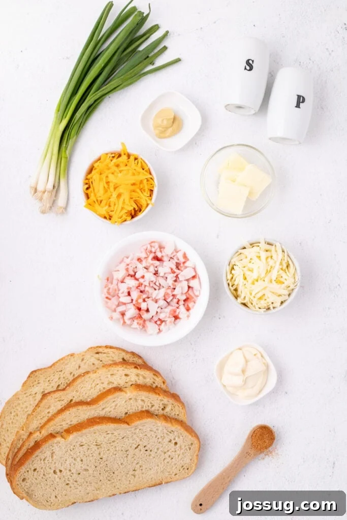 Cheesy Crab Melt: Seafood Grilled Cheese Sandwich Recipe 3 Ingredients for Cheesy Crab Melt including bread, imitation crab, shredded cheeses, mayonnaise, mustard, butter, green onions, and seasoning arranged on a countertop