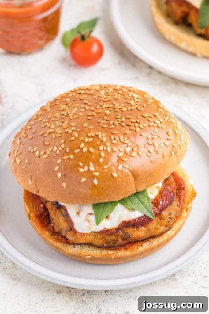 Crispy Chicken Parmesan Burgers with Marinara and Mozzarella 12 Chicken Parm Burger with marinara sauce, mozzarella cheese, and basil on a sesame seed bun