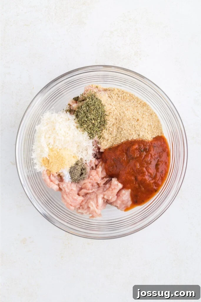 Crispy Chicken Parmesan Burgers with Marinara and Mozzarella 5 Ground chicken, marinara sauce, breadcrumbs, Parmesan cheese, and seasonings in a glass mixing bowl
