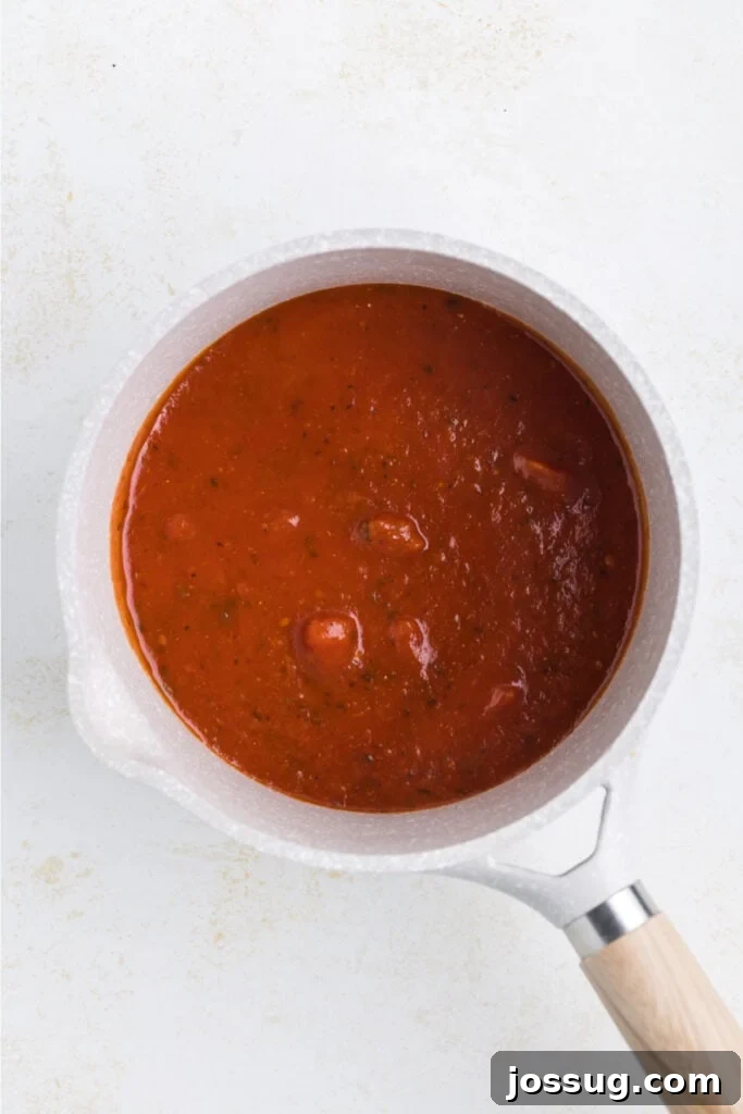 Crispy Chicken Parmesan Burgers with Marinara and Mozzarella 8 Marinara sauce warming in a small saucepan