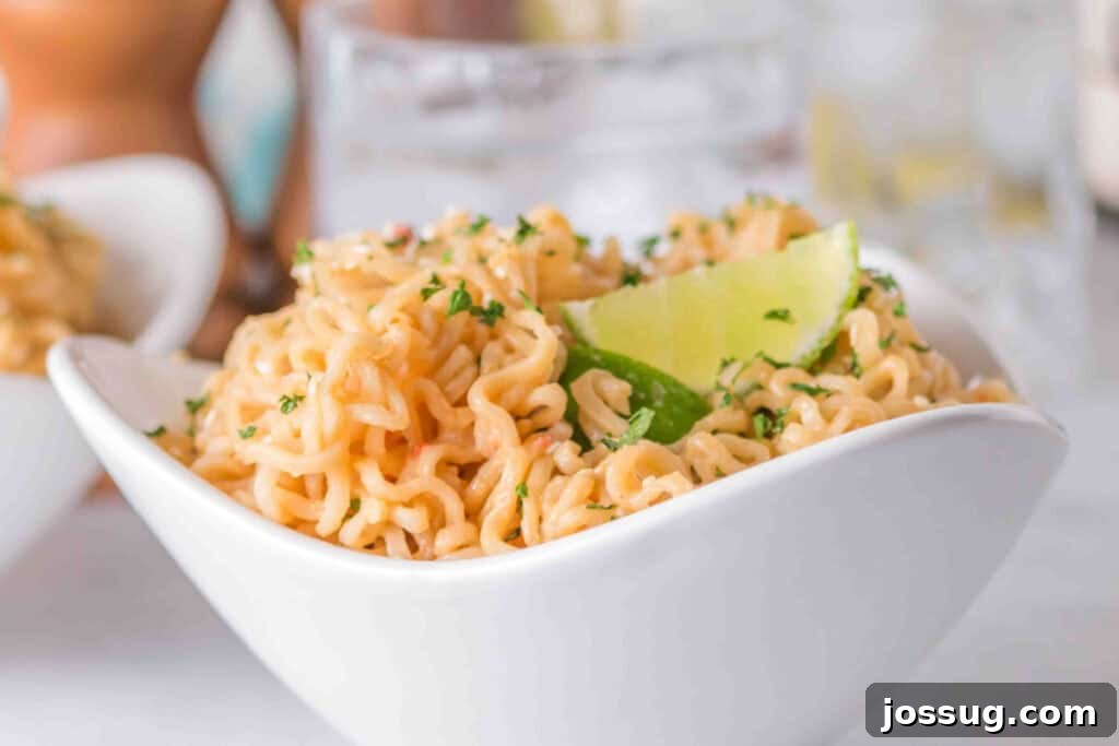 Creamy Peanut Butter Ramen Noodles Recipe in 10 Minutes 8 Creamy Peanut Butter Ramen Noodles served in a white bowl with sesame seeds, parsley, lime wedges, and chopsticks.
