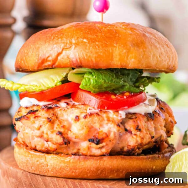 Smoky Barbecue Shrimp Po' Boy Sandwich Recipe 13 Square close-up of a grilled salmon burger on a brioche bun with lettuce, tomato, and mayo
