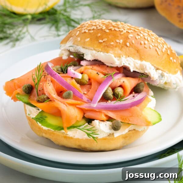 Smoky Barbecue Shrimp Po' Boy Sandwich Recipe 14 Square image of a smoked salmon bagel sandwich with cream cheese, red onions, capers, dill, and cucumber on a sesame bagel.