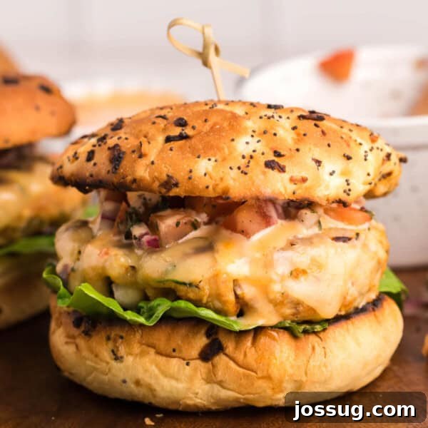 closeup of a chicken burger on cutting board