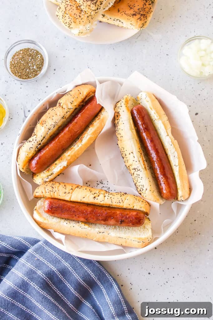 Toasted poppy seed buns filled with browned all-beef hot dogs before adding toppings