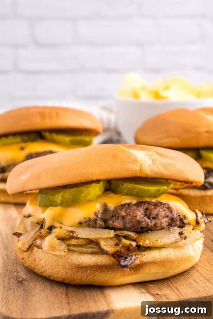 Oklahoma Onion Smash Burger Recipe with Caramelized Onions 2 Oklahoma Onion Burger with caramelized onions, melted cheese, and pickles
