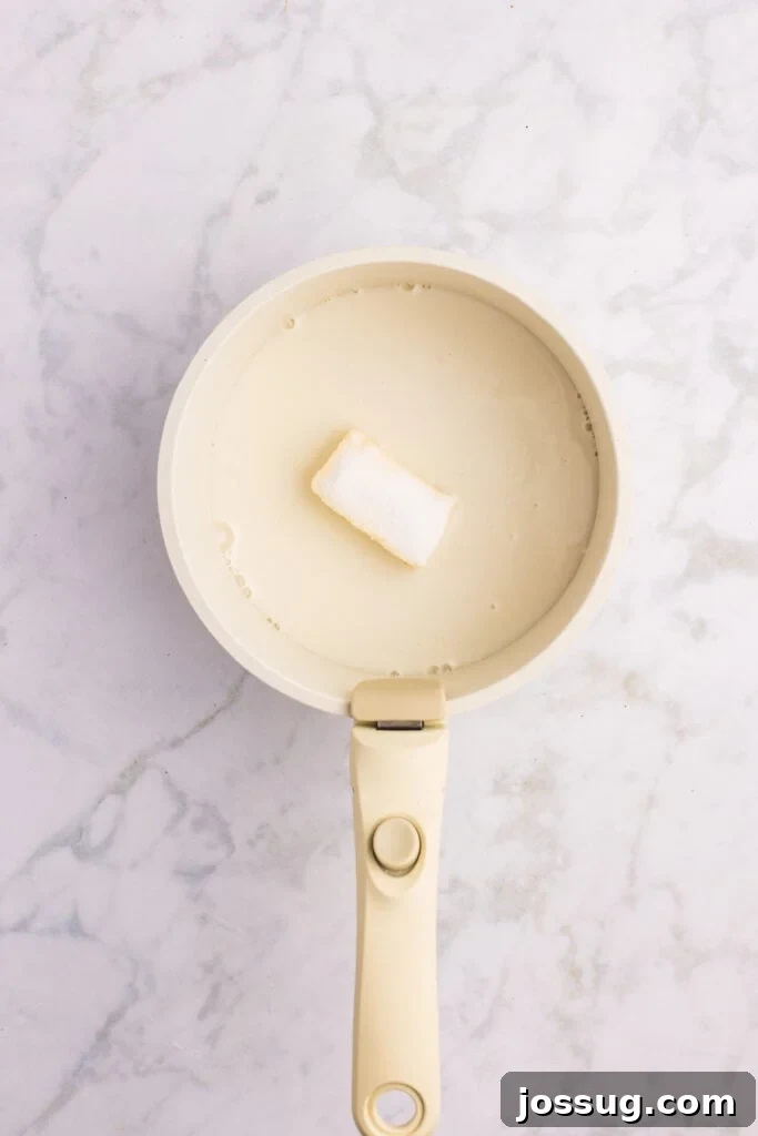 How to Make Soft Homemade Hamburger Buns 6 Milk, butter, sugar, and salt warming in a saucepan for hamburger bun dough