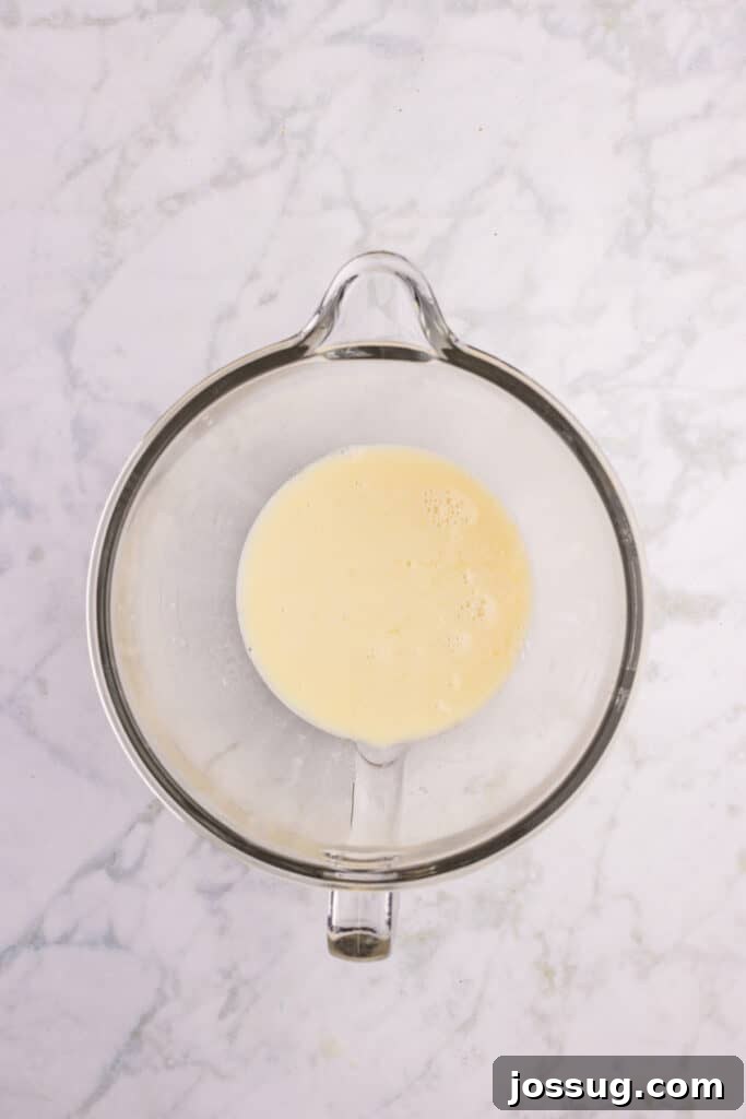 How to Make Soft Homemade Hamburger Buns 8 Warm milk mixture poured into the bowl of a stand mixer