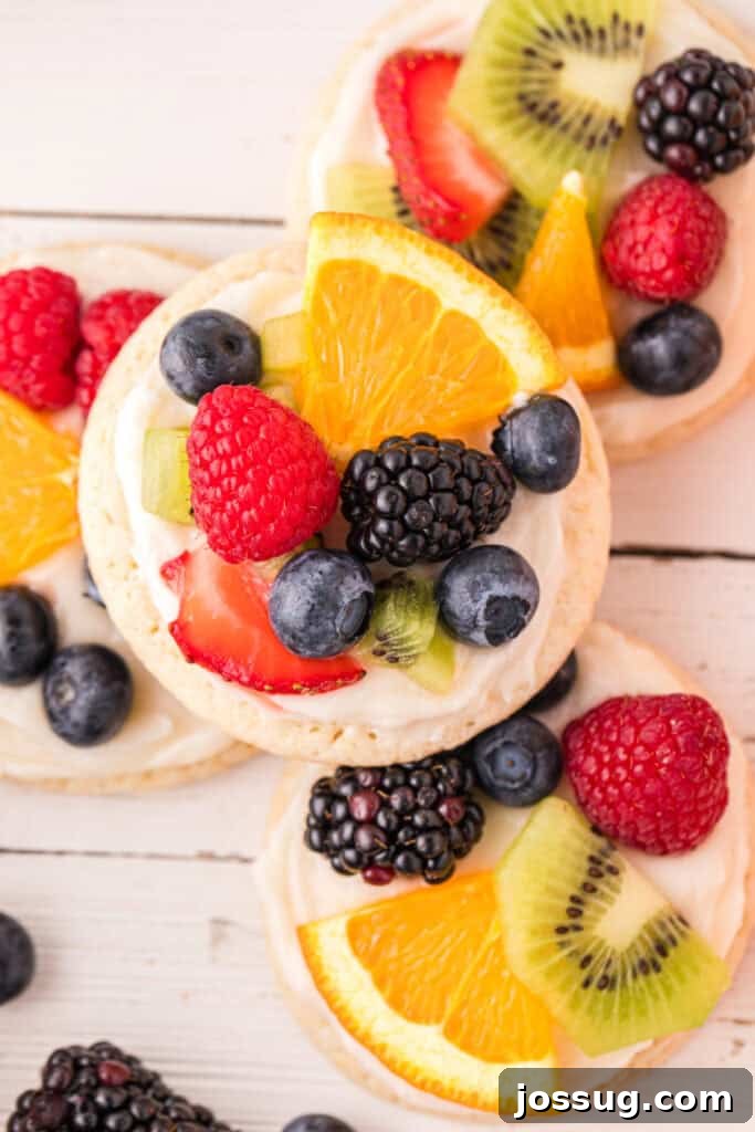 Fruit Pizza Cookies: Sugar Cookie Dessert with Fresh Fruit 2 Close-up of a homemade Fruit Pizza Cookie topped with cream cheese frosting and fresh fruit.