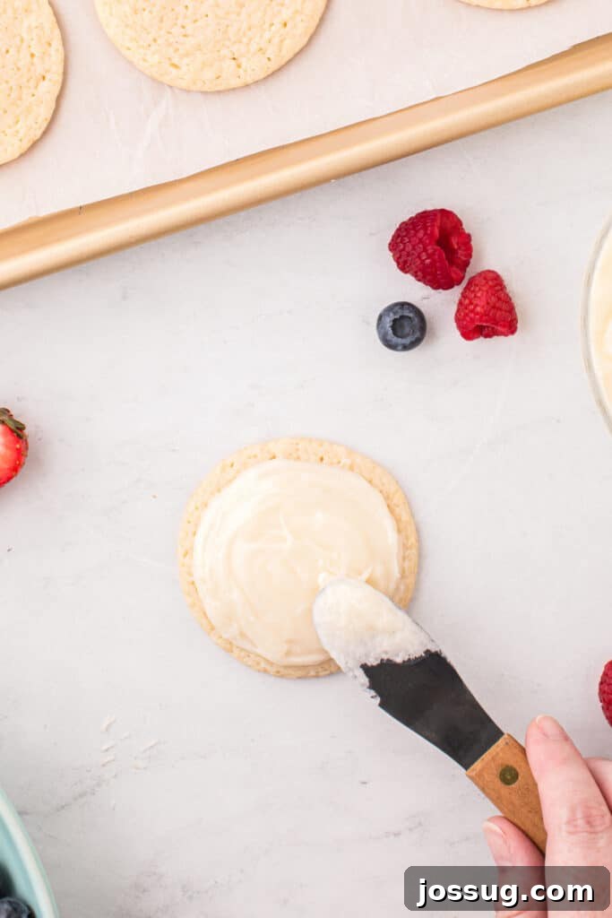 Fruit Pizza Cookies: Sugar Cookie Dessert with Fresh Fruit 13 Cream cheese frosting spread over a cooled sugar cookie before decorating.