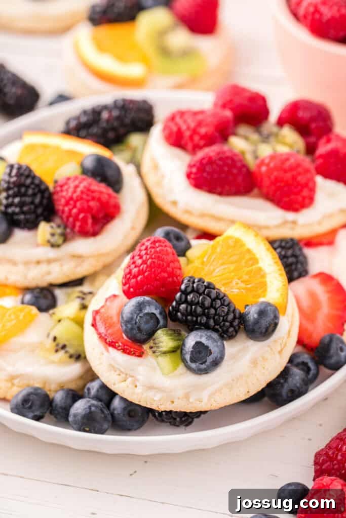 Fruit Pizza Cookies: Sugar Cookie Dessert with Fresh Fruit 16 Platter of homemade Fruit Pizza Cookies topped with cream cheese frosting and fresh fruit.