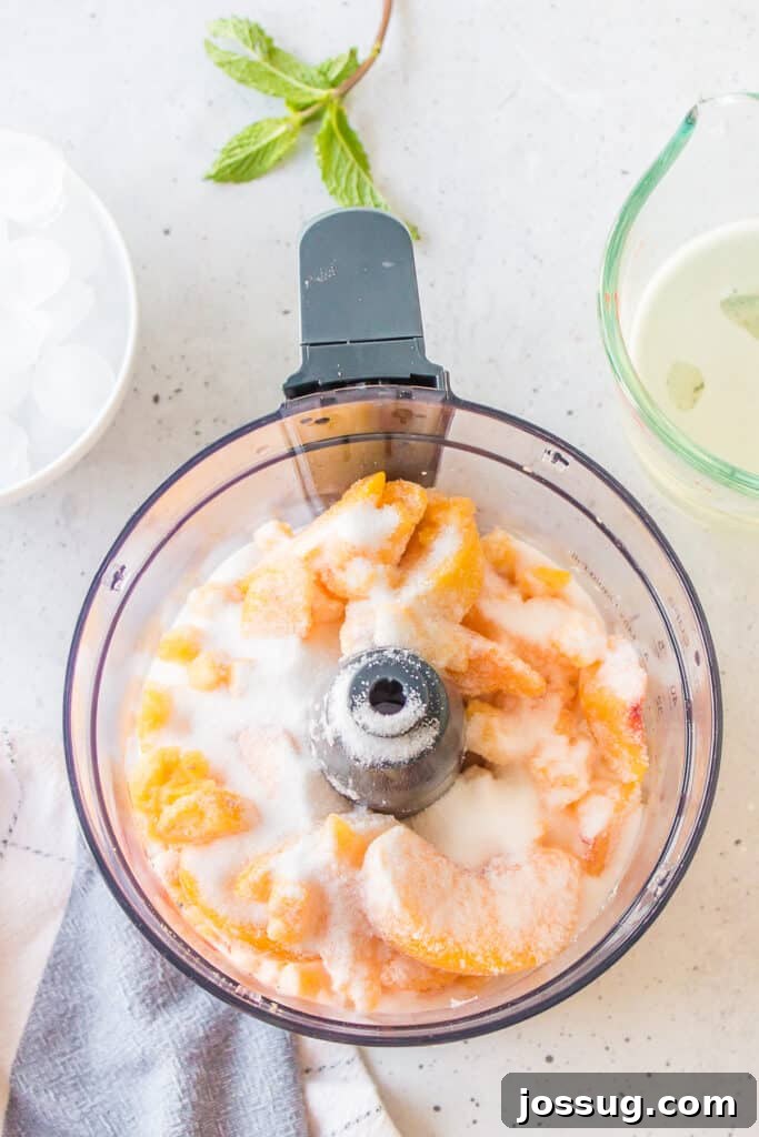 Frozen Peach Bellini Cocktail Recipe for Summer 5 Frozen peaches and granulated sugar in a food processor before blending for a Frozen Peach Bellini.