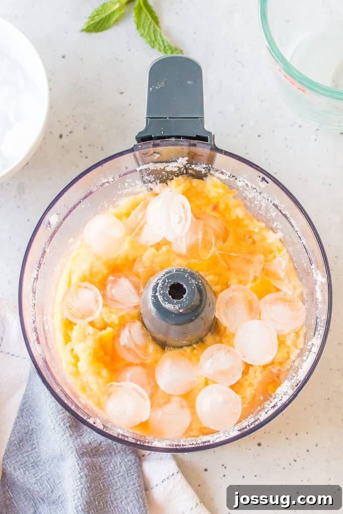 Frozen Peach Bellini Cocktail Recipe for Summer 6 Frozen peaches mixed with ice before blending into a frozen peach cocktail.