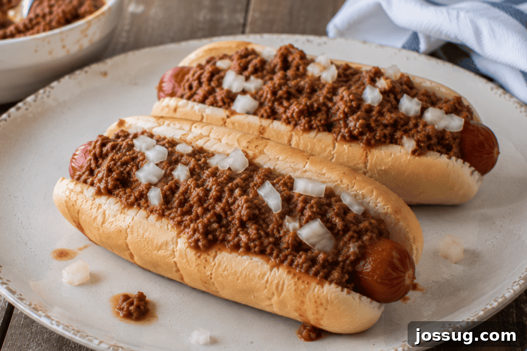 Slow Cooker Hot Dog Chili with Homemade Chili Sauce 4 Slow Cooker Hot Dog Chili served on a hot dog with diced onions for an easy homemade chili