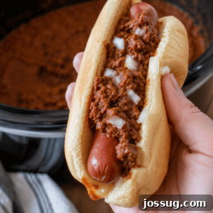 Slow Cooker Hot Dog Chili with Homemade Chili Sauce 10 Homemade chili dog topped with Slow Cooker Hot Dog Chili in a square food photo.