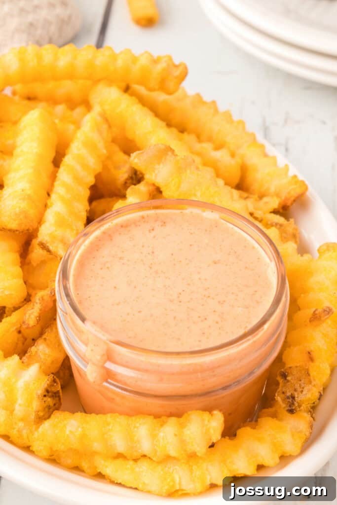 Homemade Fry Sauce Recipe: Tangy Dipping Sauce 2 Creamy homemade Fry Sauce served with hot, crispy crinkle-cut French fries.