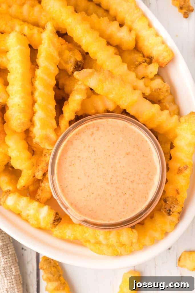 Homemade Fry Sauce Recipe: Tangy Dipping Sauce 9 Overhead view of homemade Fry Sauce served with crispy crinkle-cut French fries.