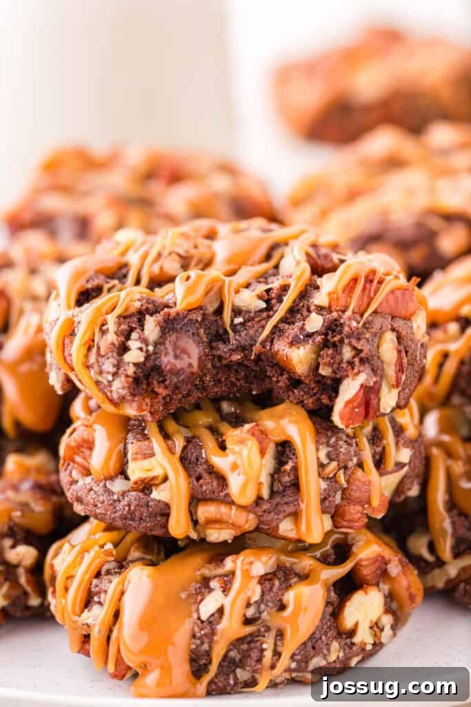 Stack of Easy Turtle Cookies drizzled with caramel on a serving plate.