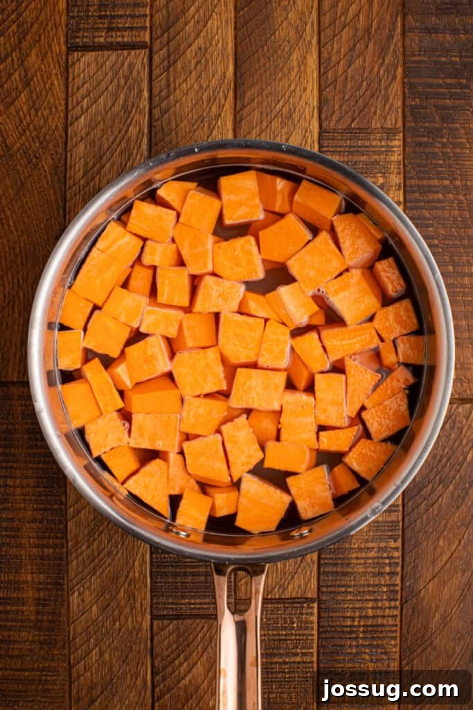 Southern-Style Sweet Potato Salad Recipe 5 Peeled sweet potato cubes cooking in a pot of salted water until fork tender