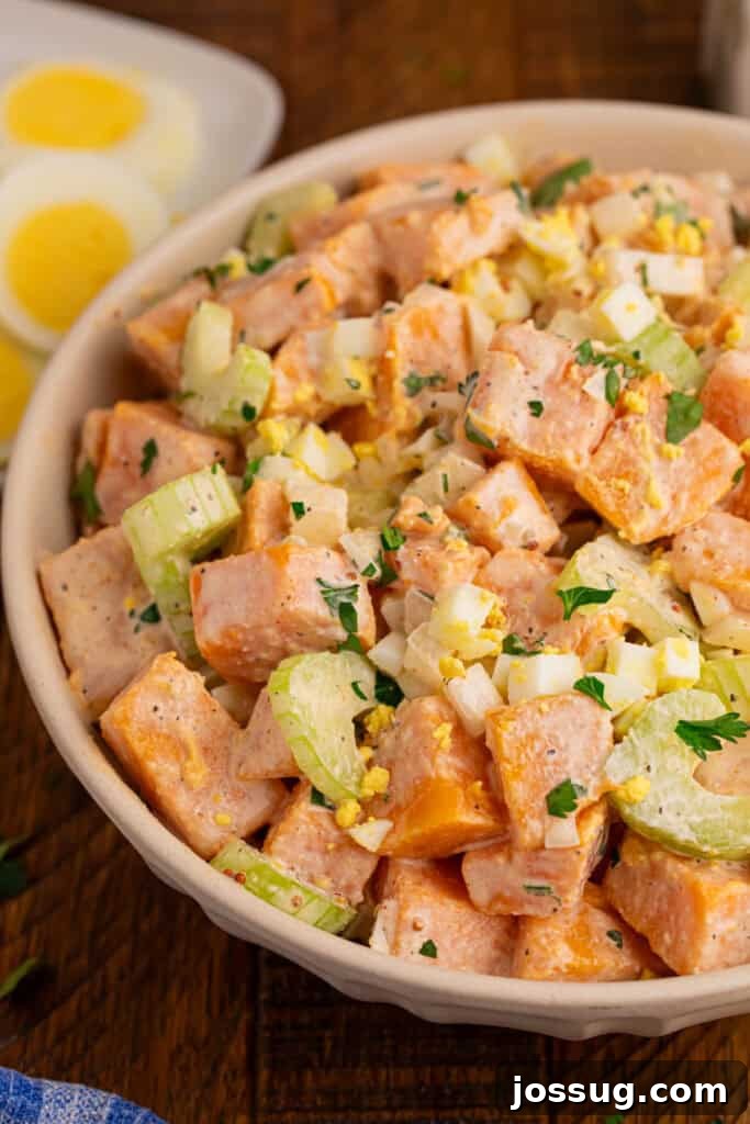 Southern-Style Sweet Potato Salad Recipe 8 Close-up of creamy Sweet Potato Salad with tender sweet potatoes, celery, chopped eggs, onion, and fresh parsley
