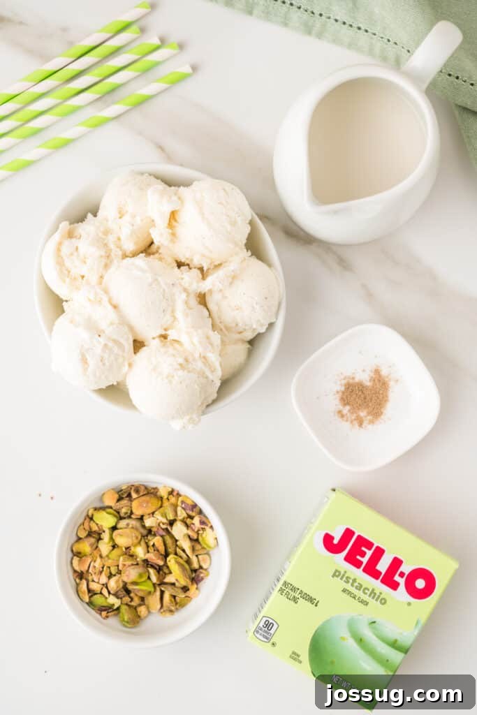 Ingredients for a pistachio milkshake including vanilla ice cream, milk, pistachio pudding mix, cardamom, and chopped pistachios