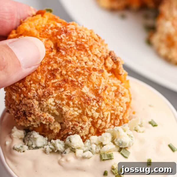 buffalo chicken popper being dipped into blue cheese dip